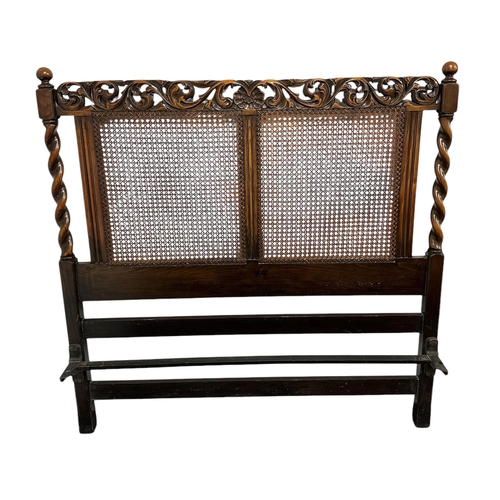 906 - A 17th century style carved oak bed frame with bergere panels, 138cms wide (3).