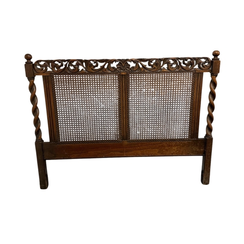 906 - A 17th century style carved oak bed frame with bergere panels, 138cms wide (3).