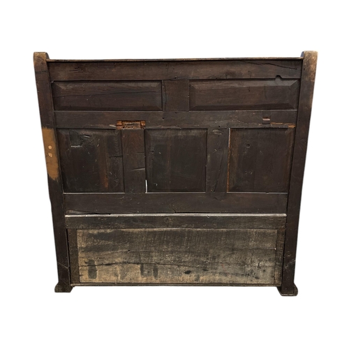 908 - A 19th century oak box settle with carved three-panelled back, scroll arms, the box section with thr... 