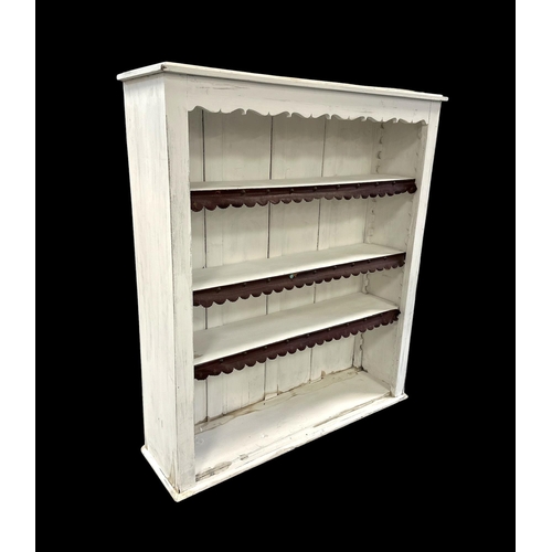 911 - A painted open bookcase with leather trim to the shelves, 98cms wide.