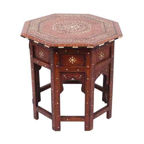 914 - A Syrian or Moroccan octagonal side table with bone inlaid decoration, 46cms wide.