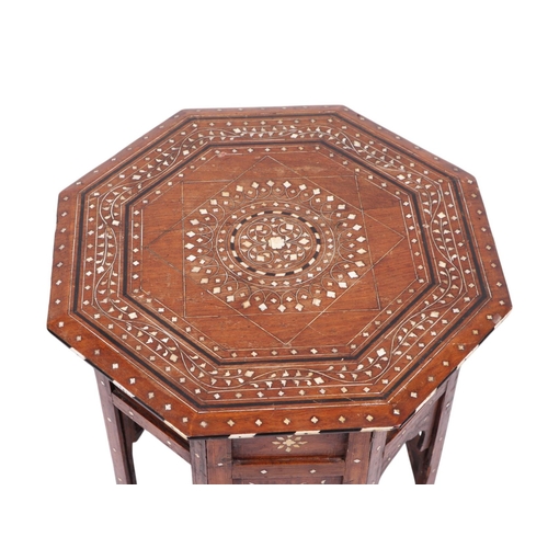 914 - A Syrian or Moroccan octagonal side table with bone inlaid decoration, 46cms wide.