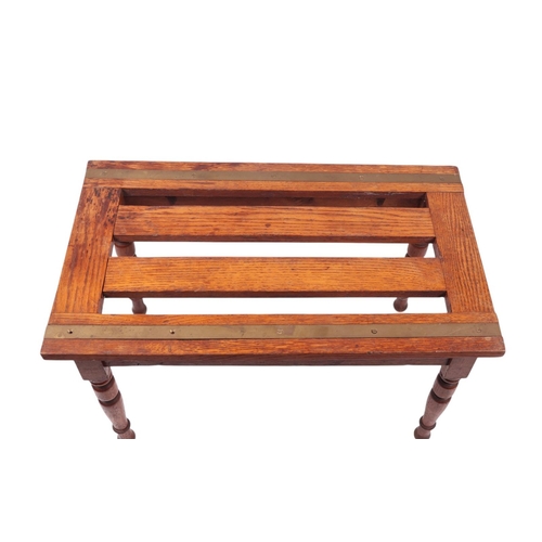 916 - An Edwardian oak & brass luggage stand on turned supports, 75cms wide.