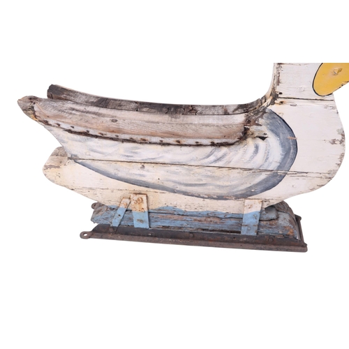 917 - Folk Art.  A carved and painted wooden swan fairground ride, approx 103cms long.