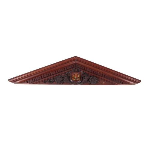 918 - A carved mahogany architectural pediment decorated with the Royal Coat of Arms, 148cms wide.