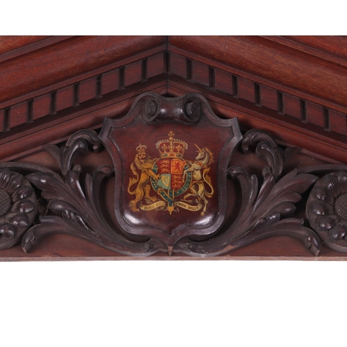 918 - A carved mahogany architectural pediment decorated with the Royal Coat of Arms, 148cms wide.