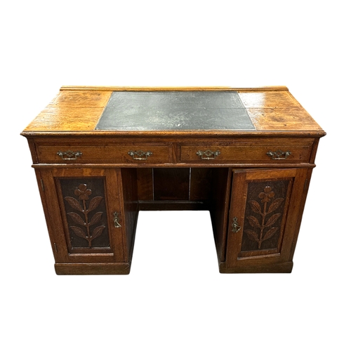 907 - A late 19th / early 20th century oak pedestal desk with an arrangement of drawers and cupboards, on ... 