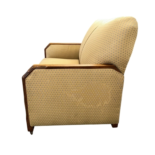 1018 - An Art Deco upholstered three-piece suite with carved show wood, sofa 102cms wide (3).