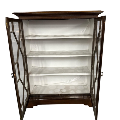 1029 - An Edwardian mahogany display cabinet, the pair of astragal glazed doors enclosing a shelved interio... 