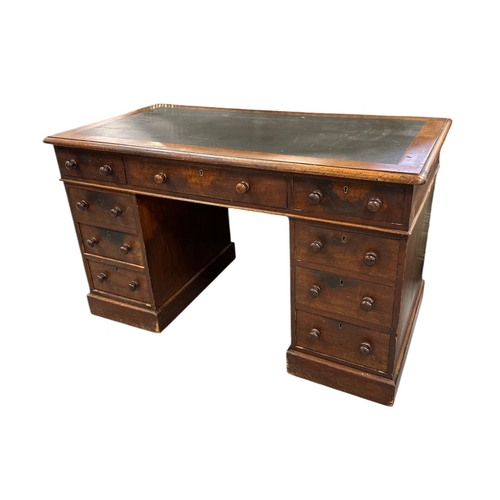 1032 - A late Victorian mahogany pedestal desk with an arrangement of nine drawers, on a plinth base, 118cm... 