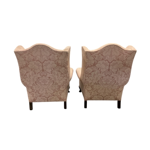 1040 - A pair of wingback armchairs on dwarf cabriole front supports (2)