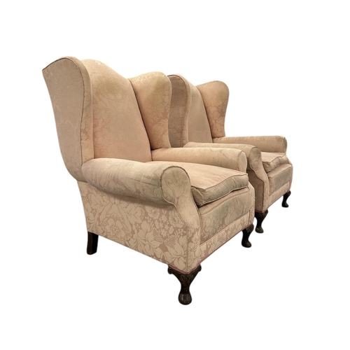 1040 - A pair of wingback armchairs on dwarf cabriole front supports (2)