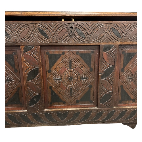 1042 - A 17th century and later carved oak coffer on stile legs, 110cms wide.