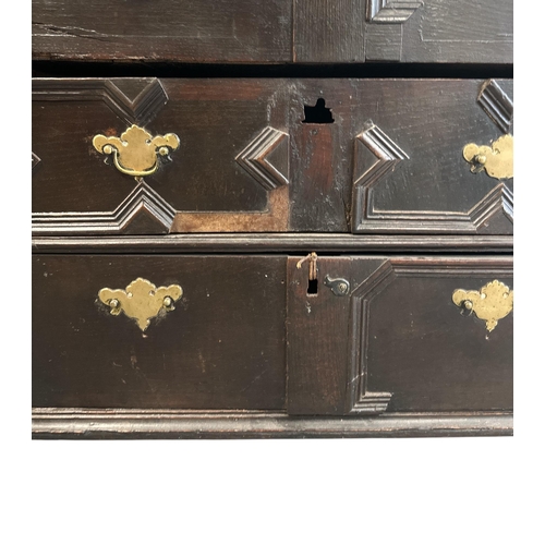 1060 - An 18th century oak chest with geometric moulding, with two short and three graduated long drawers, ... 