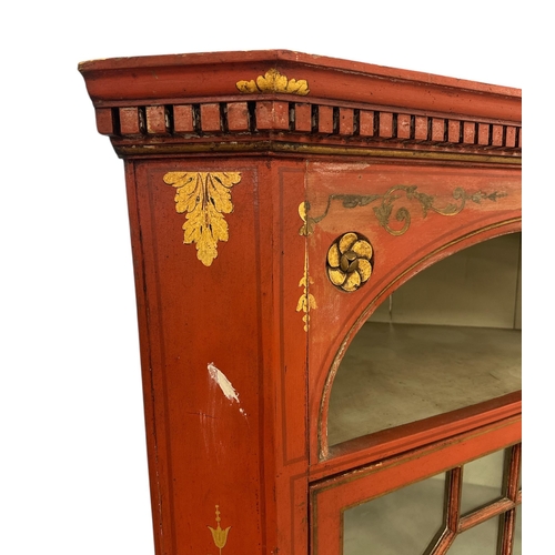 1061 - An early 19th painted and gilded floor standing corner cupboard, the astragal glazed door enclosing ... 