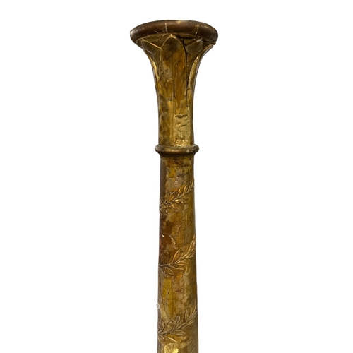 1067 - A tall giltwood column or torchere with scrolling vine decoration, 180cms high.