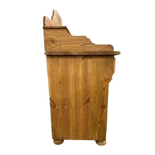 1081 - A continantal pine side cabinet, the single drawer above a field panelled door enclosing a shelved i... 