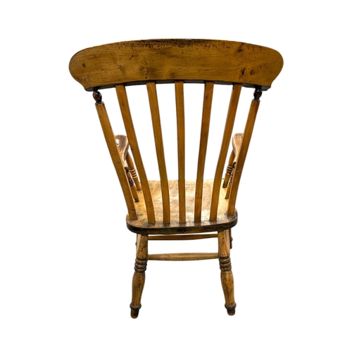 1085 - A beech and elm Windsor chair with solid seat and turned front legs joined by an H stretcher.