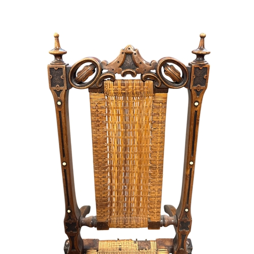 1089 - A 19th century folding Campaign chair in stained and carved beech with rattan seat and back panel.