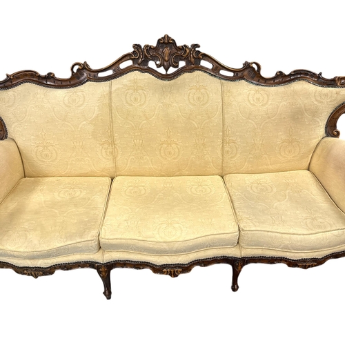 1090 - A continental carved walnut and upholstered three-piece suite in the French taste, each piece with s... 