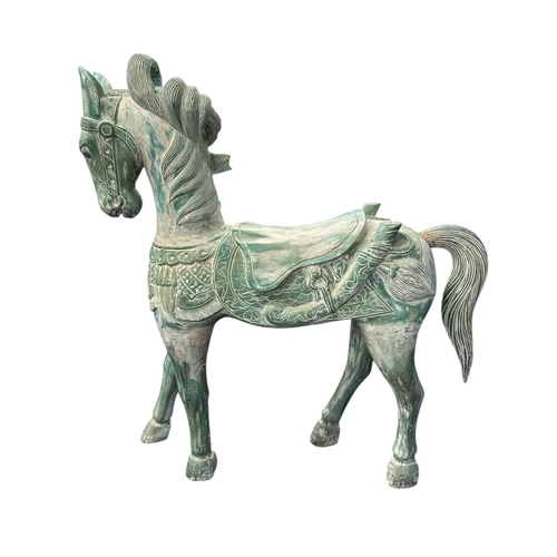 1092 - A large Balinese carved and painted figure of a horse, approx 135cms high.