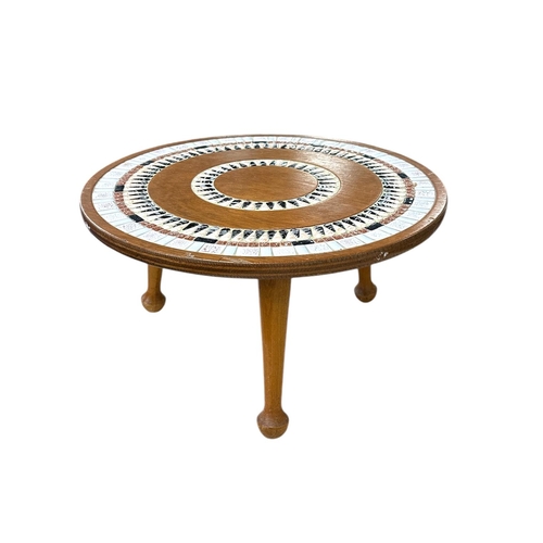 1093 - A mid 20th century design nest of three tile topped tables, the largest 96cms wide; together with a ... 