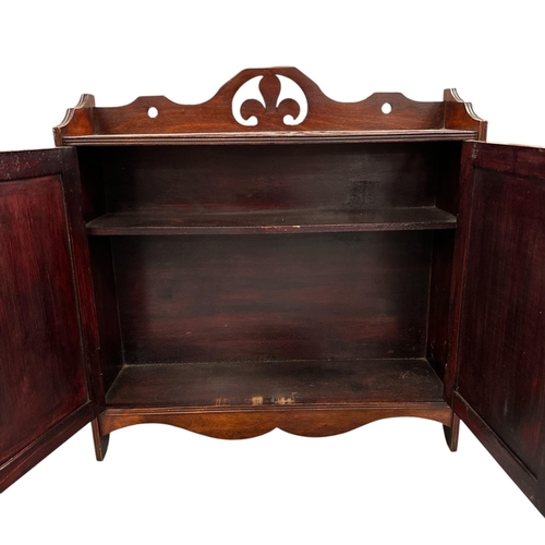 1098 - A late 19th century walnut wall cupboard, the pair of panelled doors enclosing a shelved interior, 5... 