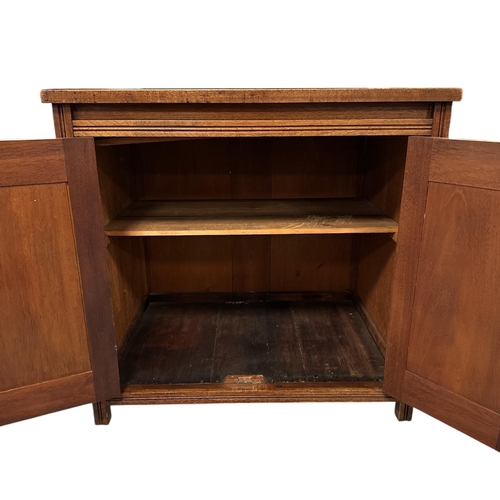 1115 - A late 19th century walnut side cabinet, the pair of panelled doors enclosing a shelved interior, 73... 