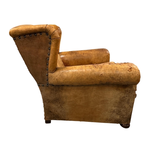 1116 - An early 20th century leather club armchair.