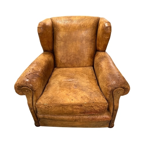 1116 - An early 20th century leather club armchair.