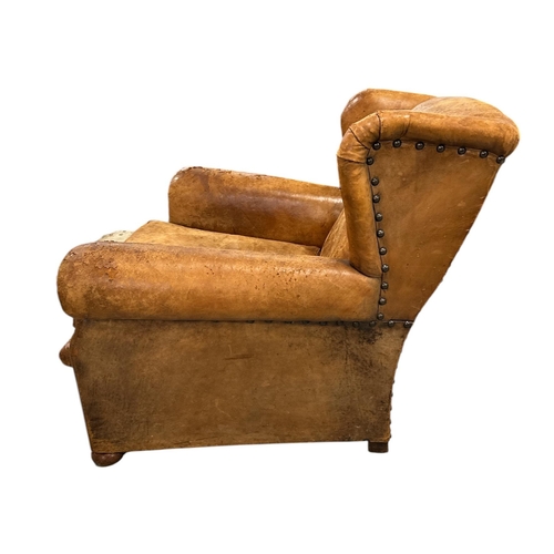 1116 - An early 20th century leather club armchair.