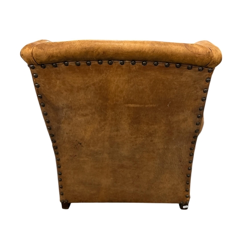 1116 - An early 20th century leather club armchair.