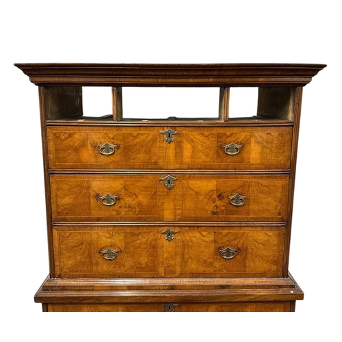 1117 - A George III walnut and crossbanded chest-on-chest, the upper section with a moulded cornice above t... 