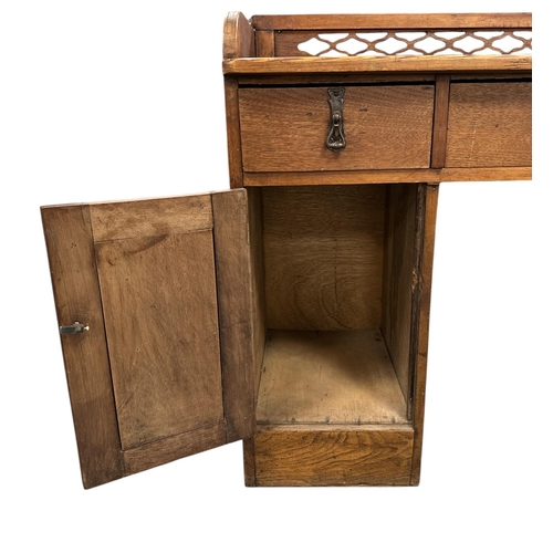 1131 - A late 19th century pitch pine and walnut kneehole desk with an arrangement of three drawers and two... 