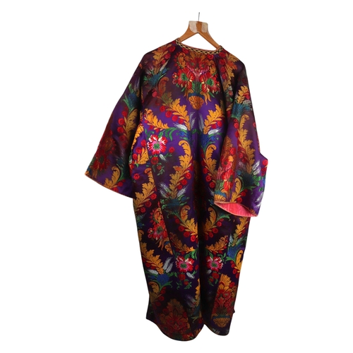 165 - A Moroccan embroidered kaftan decorated with flowers on a purple ground.