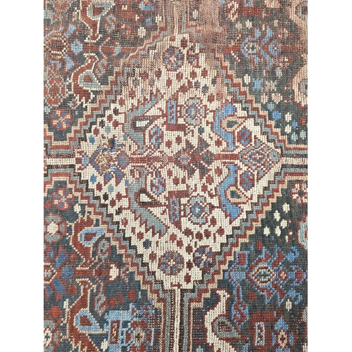 169 - A Persian Heriz woollen hand knotted rug, 150 by 195cms.