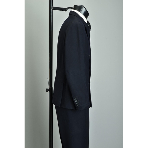 219 - A Gieves 1959 Suit. Demob style navy blue two-piece with peak lapels (ref JRQ).