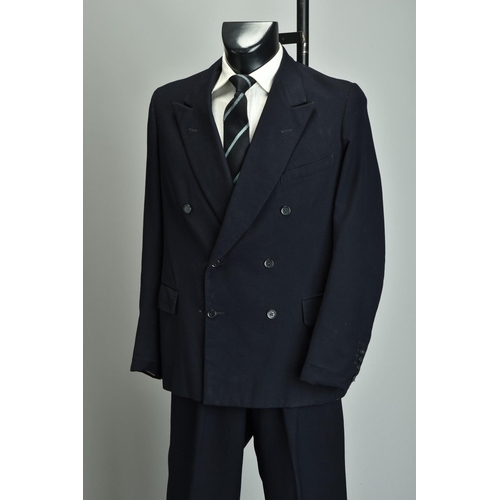 219 - A Gieves 1959 Suit. Demob style navy blue two-piece with peak lapels (ref JRQ).