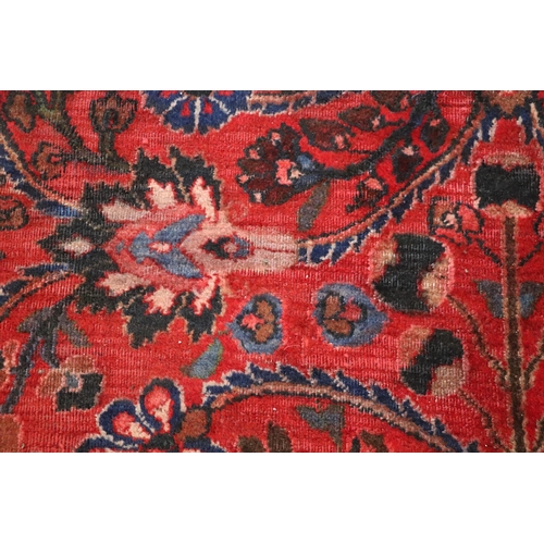 260 - A Persian Kerman hand knotted woollen carpet with repeat floral design within floral borders, on a r... 