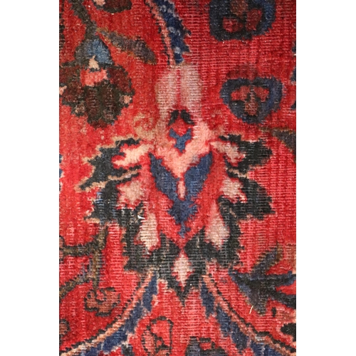 260 - A Persian Kerman hand knotted woollen carpet with repeat floral design within floral borders, on a r... 