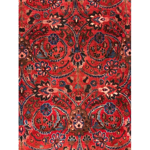 260 - A Persian Kerman hand knotted woollen carpet with repeat floral design within floral borders, on a r... 