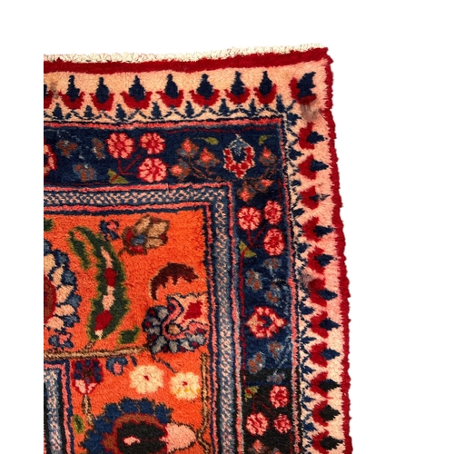 260 - A Persian Kerman hand knotted woollen carpet with repeat floral design within floral borders, on a r... 