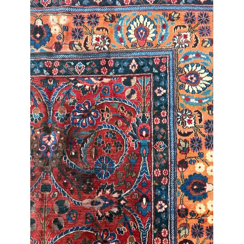 260 - A Persian Kerman hand knotted woollen carpet with repeat floral design within floral borders, on a r... 