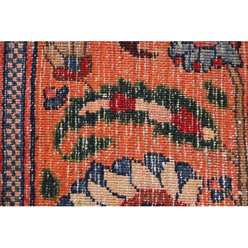 260 - A Persian Kerman hand knotted woollen carpet with repeat floral design within floral borders, on a r... 