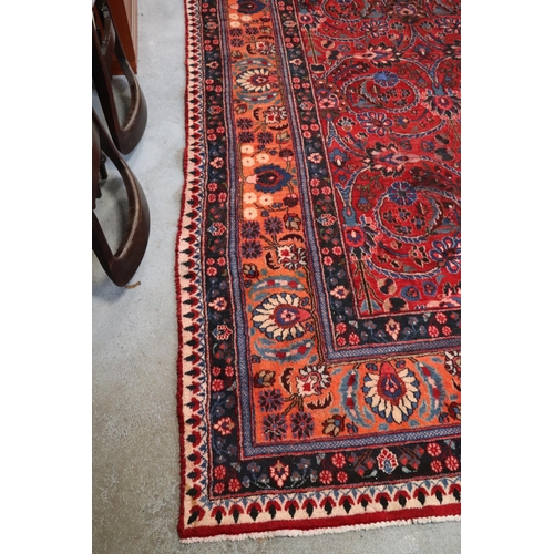 260 - A Persian Kerman hand knotted woollen carpet with repeat floral design within floral borders, on a r... 