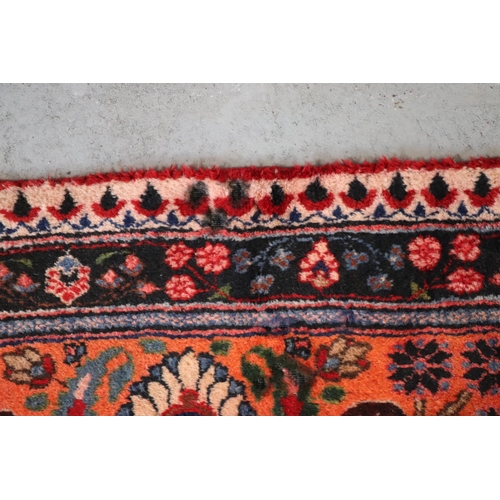 260 - A Persian Kerman hand knotted woollen carpet with repeat floral design within floral borders, on a r... 