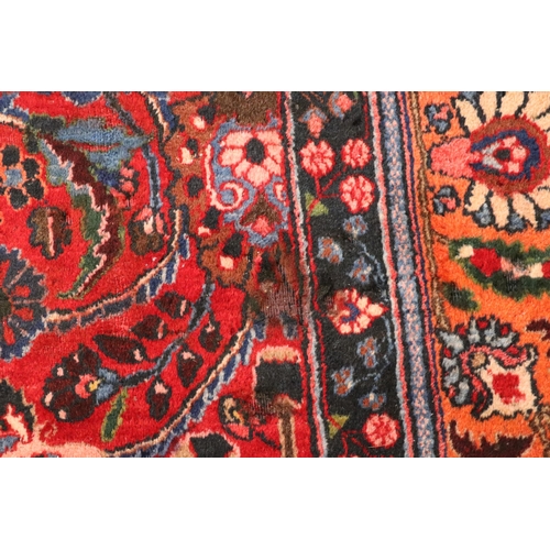 260 - A Persian Kerman hand knotted woollen carpet with repeat floral design within floral borders, on a r... 