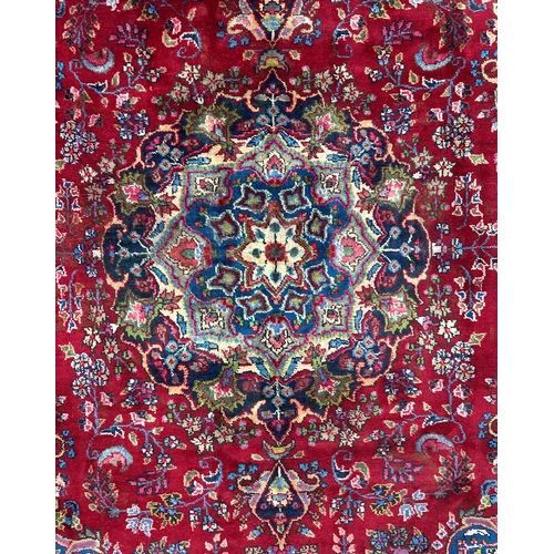 264 - A Persian Meshed woollen hand knotted rug with central floral medallion within floral borders, on a ... 