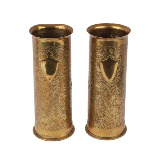 31 - A pair of WWI shell case trench art vases decorated with flowers, 23cms high (2).