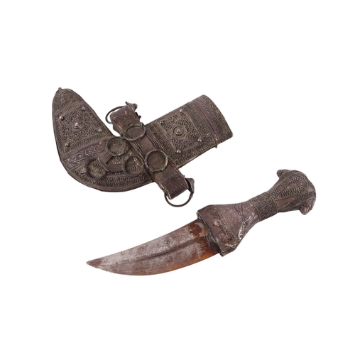 41 - A Middle Eastern jambiya dagger with white metal decorated handle and scabbard, 20cms long.